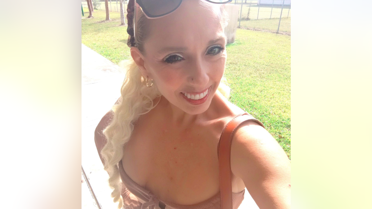 Nadyne Marie Tillman seen in a selfie wearing a dress.