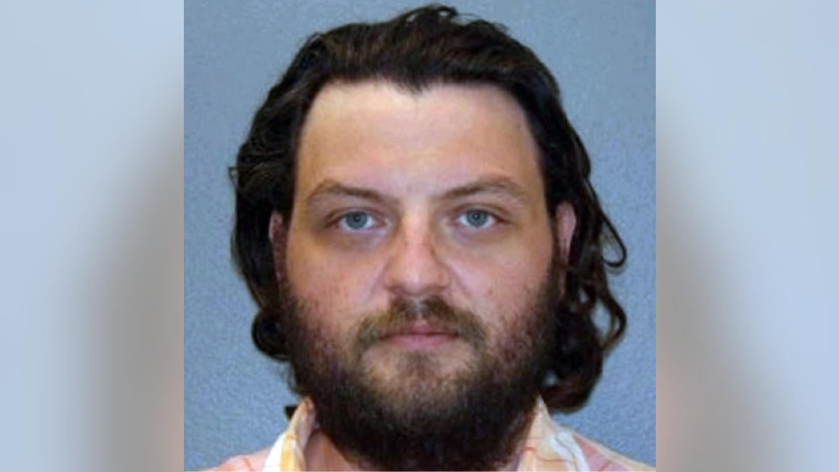 Dylan Lamb wears a collared shirt while emotionless in a booking picture.