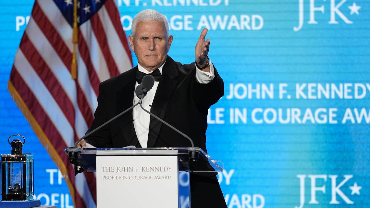 Former Vice President Mike Pence acknowledges his staff members as he speaks after receiving the John F. Kennedy Profile in Courage Award during a ceremony at the JFK Library on Sunday, May 4, 2025 in Boston.