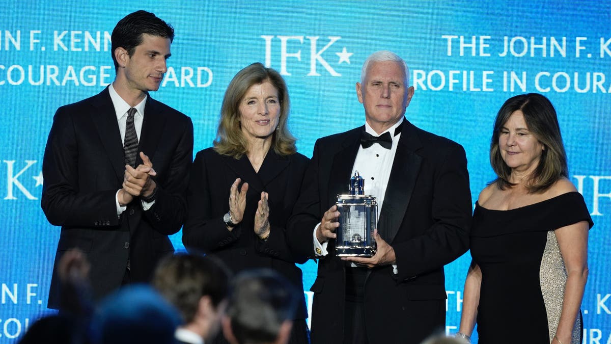 Former Vice President Mike Pence, second from right, stands with his wife, Karen Pence, far right, as he is presented with the John F. Kennedy Profile in Courage Award by Jack Schlossberg and his mother, Caroline Kennedy, at a ceremony at the JFK Library on Sunday, May 4, 2025 in Boston.