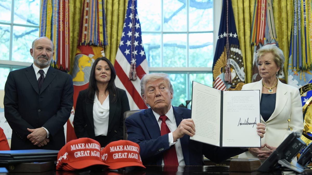 Trump shows off signed executive order