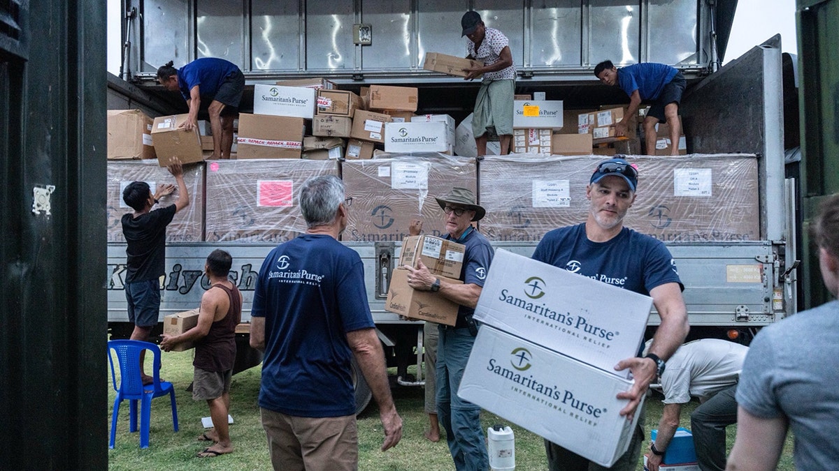 Samaritan’s Purse staff and local volunteers unload emergency relief supplies from trucks in Burma