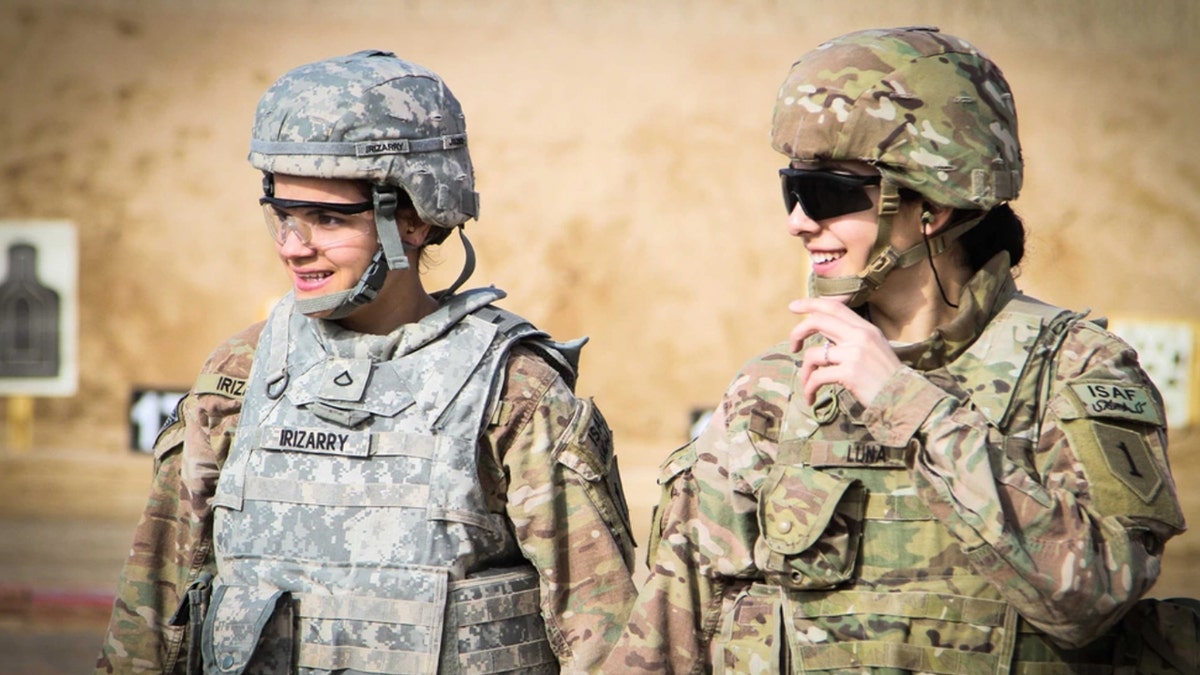 Two female soldiers walk back after checking their targets at a qualification range at Kandahar Airfield, Afghanistan, March 9, 2014. Women continue to play vital roles in all branches of the armed services, including in the combat arms, which now allows women to join since 2013. 
