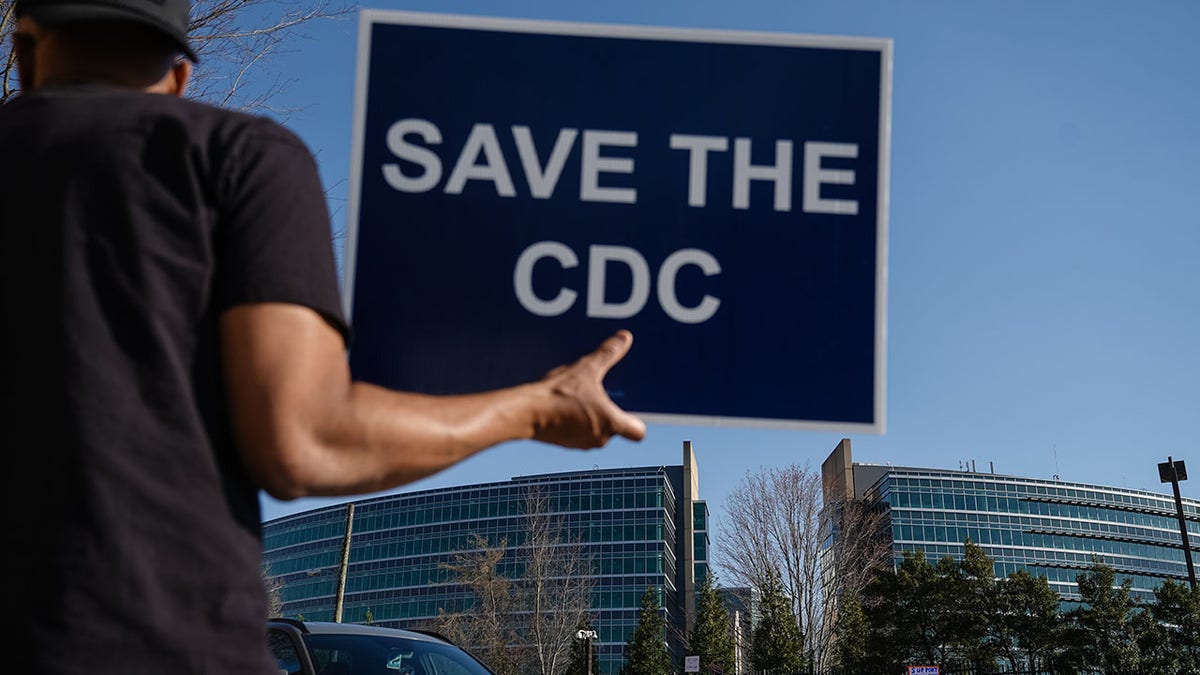 Protester carries Save The CDC