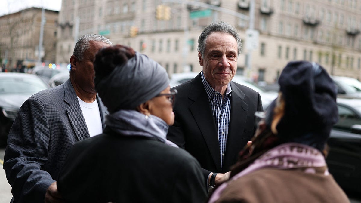 Cuomo greets people outside a Harlem church