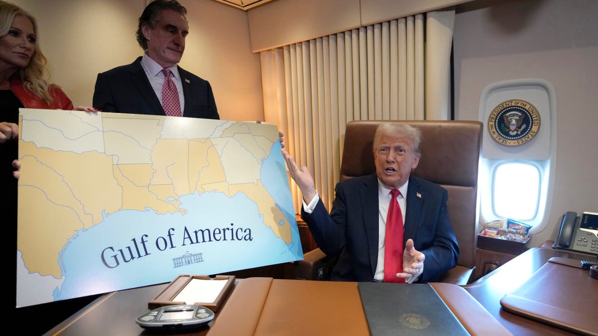 President Donald Trump speaks to reporters accompanied by Interior Secretary Doug Burgum and Burgum's wife Kathryn Burgum, aboard Air Force One, where Trump signed a proclamation declaring Feb. 9 Gulf of America Day.