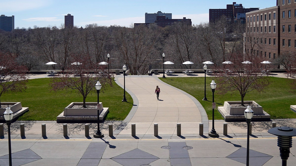 A person walks on campus at the University of Minnesota in Minneapolis.