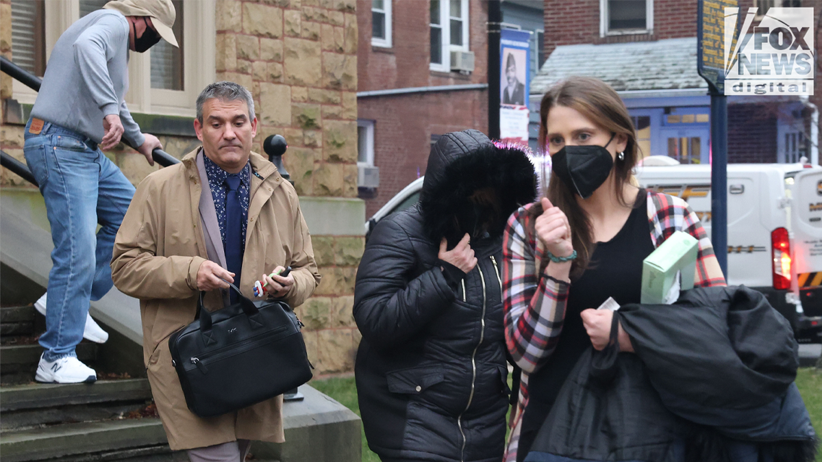 Amanda Kohberger carries a box of tissues and her coat while walking out of a courtroom in front of her parents and her brother Bryan Kohberger's former public defender, Jason LaBar