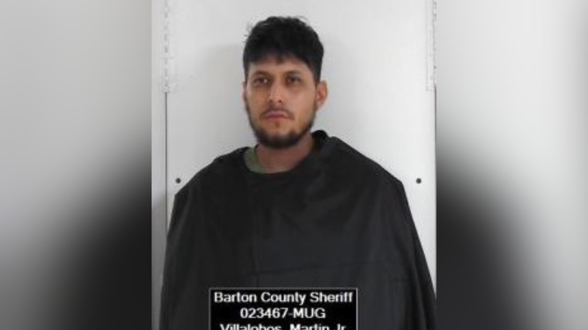 Martin Villalobos Junior, 27, wears a black robe while emotionless in a booking picture.