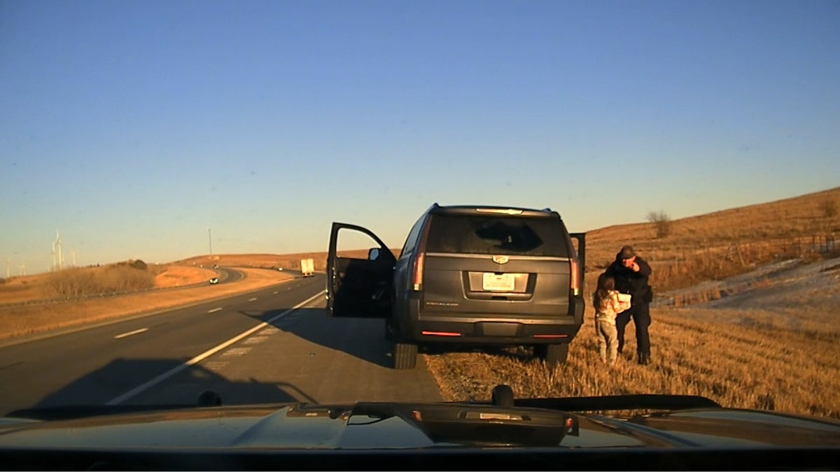 law enforcement speaks with child outside of SUV