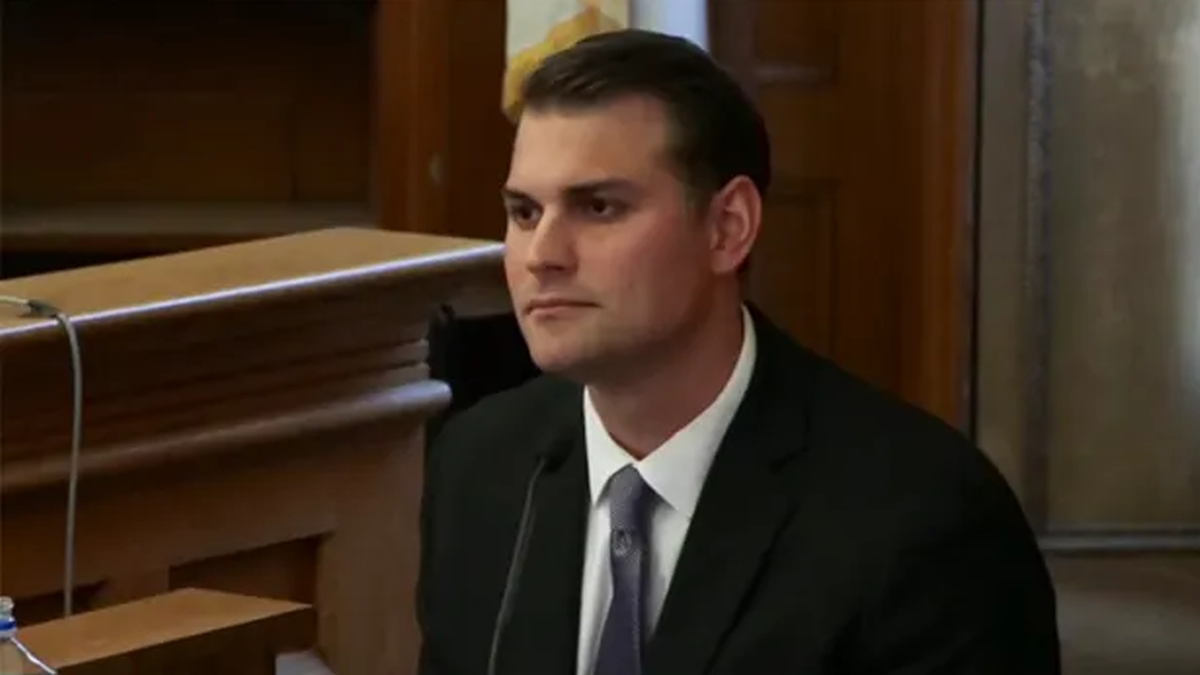 Dr Daniel Wolfe in a dark suit and clean shaved at the witness stand.