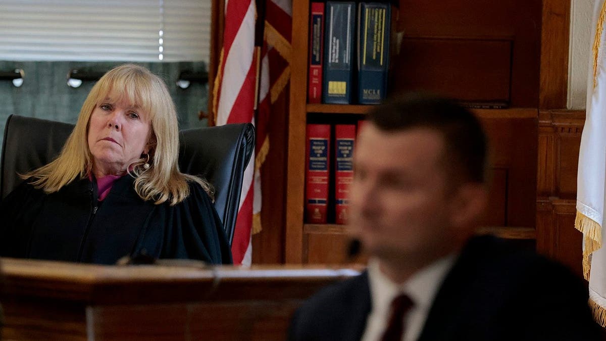 Judge Beverly J. Cannone leans to her left as Sgt Yuri Bukhenik testifies