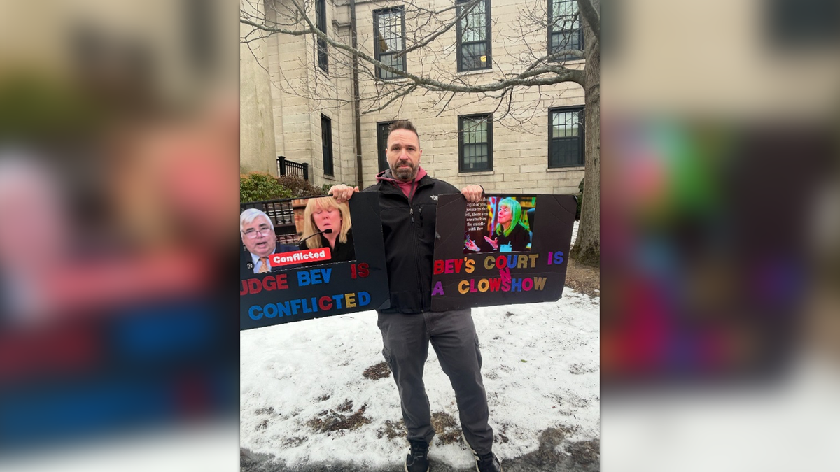 jason grant holding protest signs outside karen read court