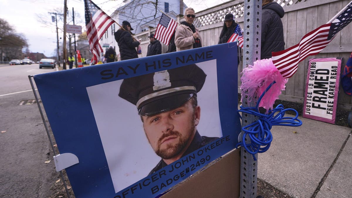 Protesters outside of Karen Read's trial carry American flags and stand near a photo of John O'Keefe, the Boston police officer boyfriend she is accused of killing