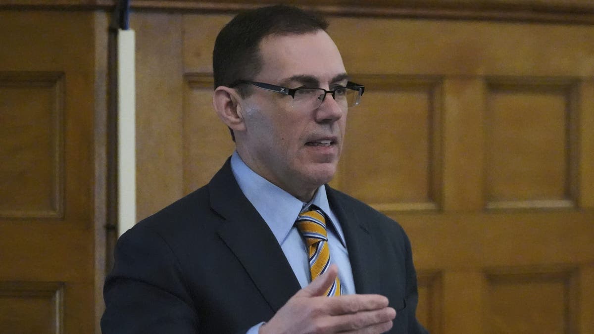 Prosecutor Hank Brennan gestures with his hand in court