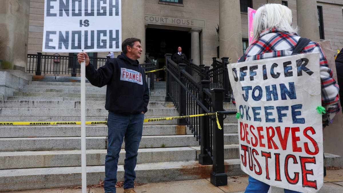 Protesters for and against Karen Read wait outside the courthouse with signs