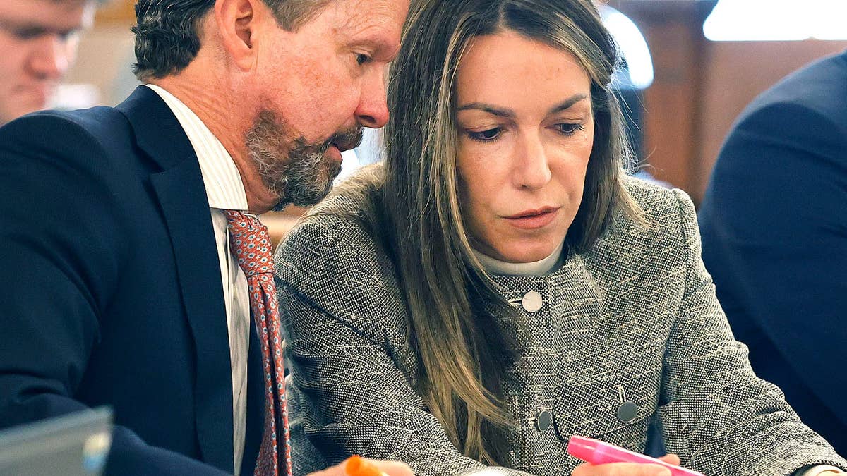 Defendant Karen Read and attorney Alan Jackson review jury questionnaires in the courthouse