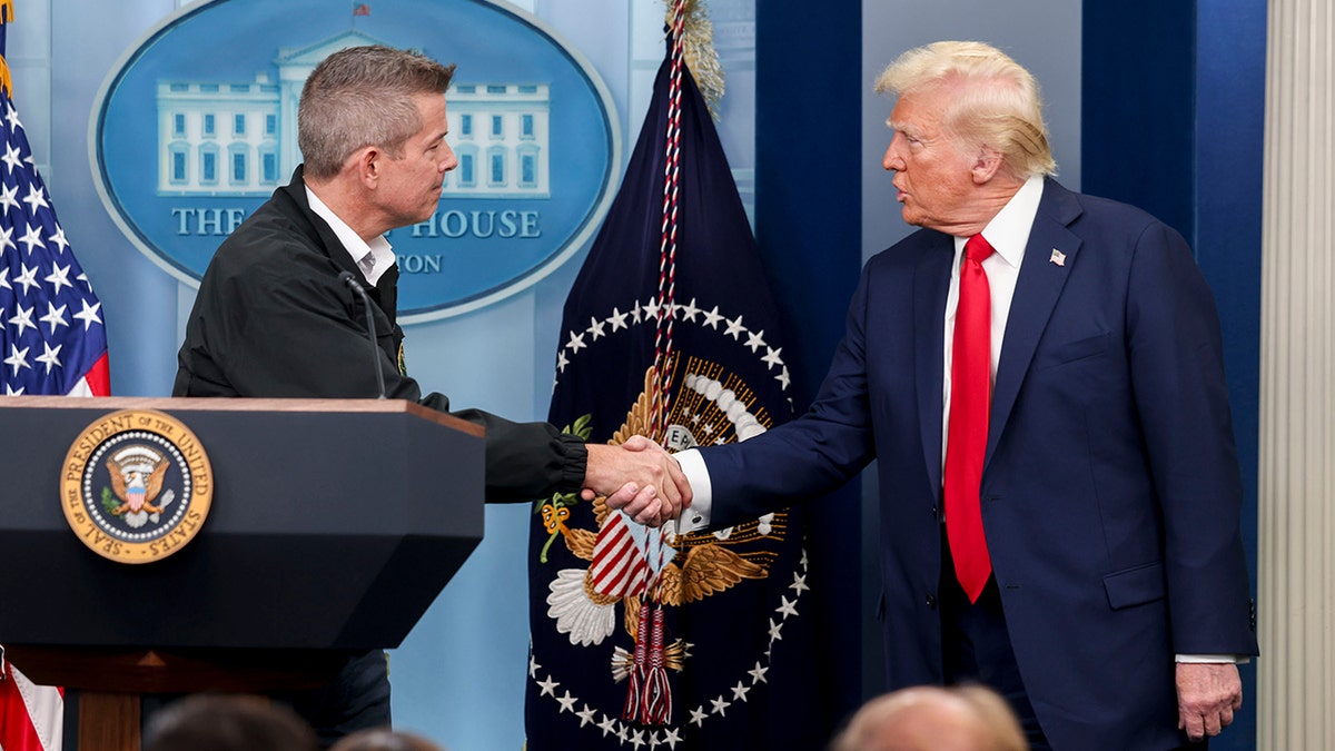 Transportation Secretary Sean Duffy and President Donald Trump shake hands