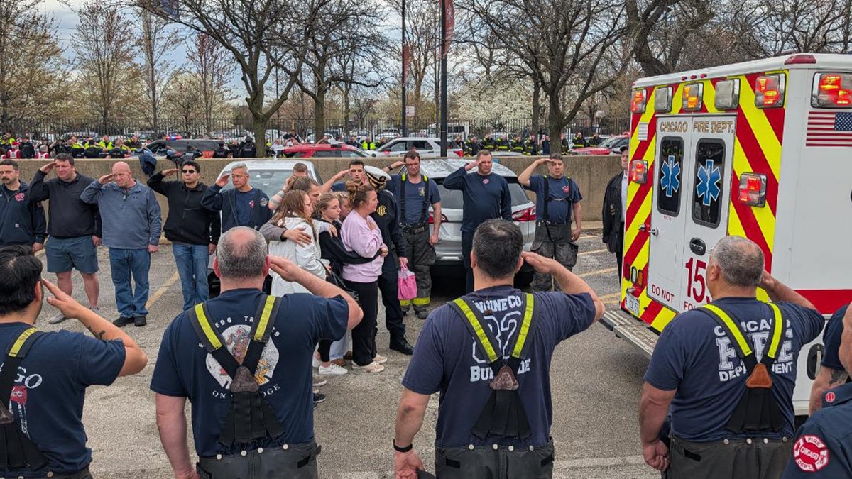 Family of fallen firefighter stands behind ambulance