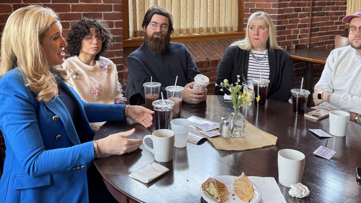 Maura Sullivan with voters at table