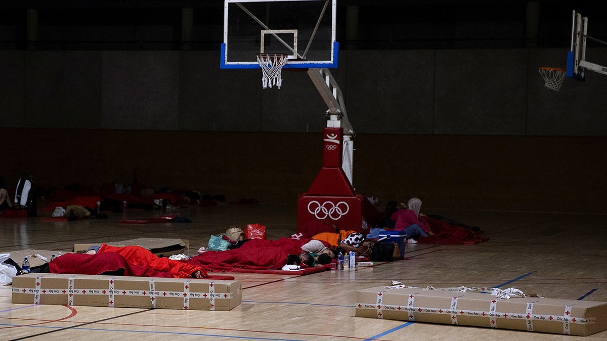 People sleep inside sports facility in Barcelona