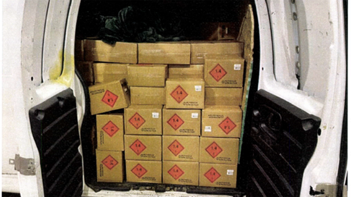 Cardboard boxes full of ammunition in the back of a white van