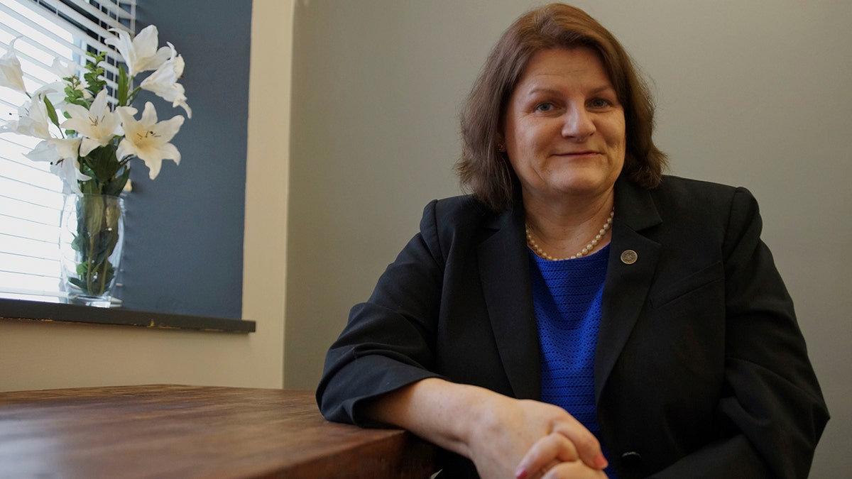 Judge Hannah Dugan leaning on counter