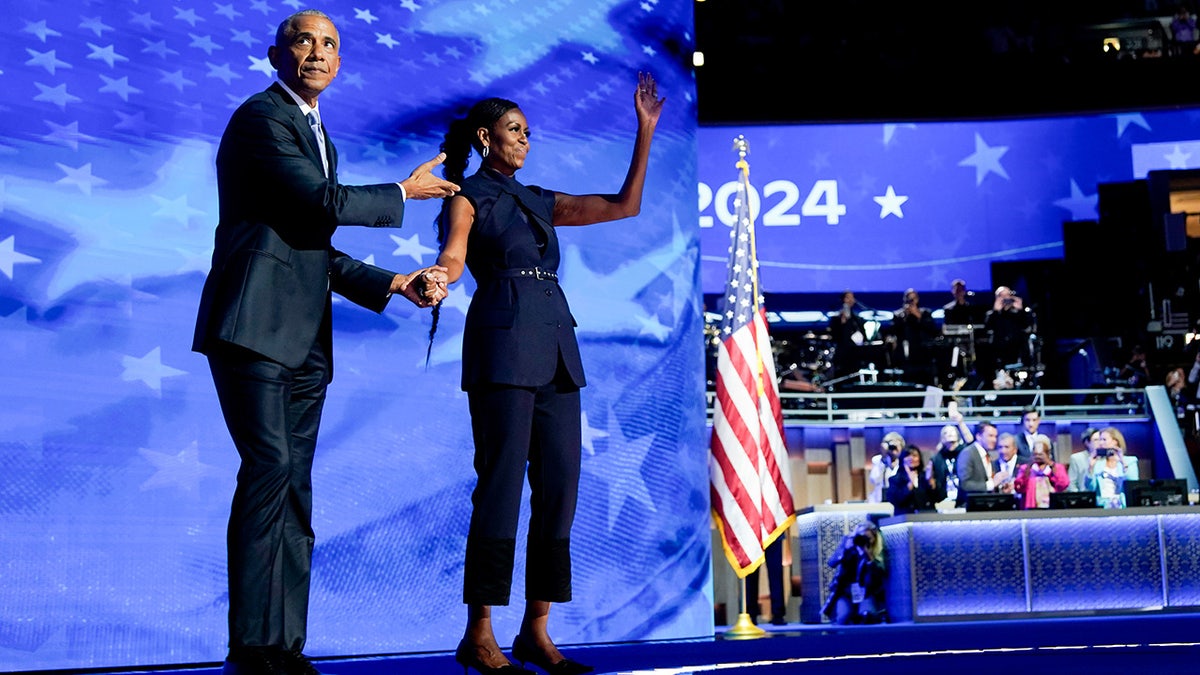 Barack Obama arrives to speak next to Michelle Obama during the Democratic National Convention