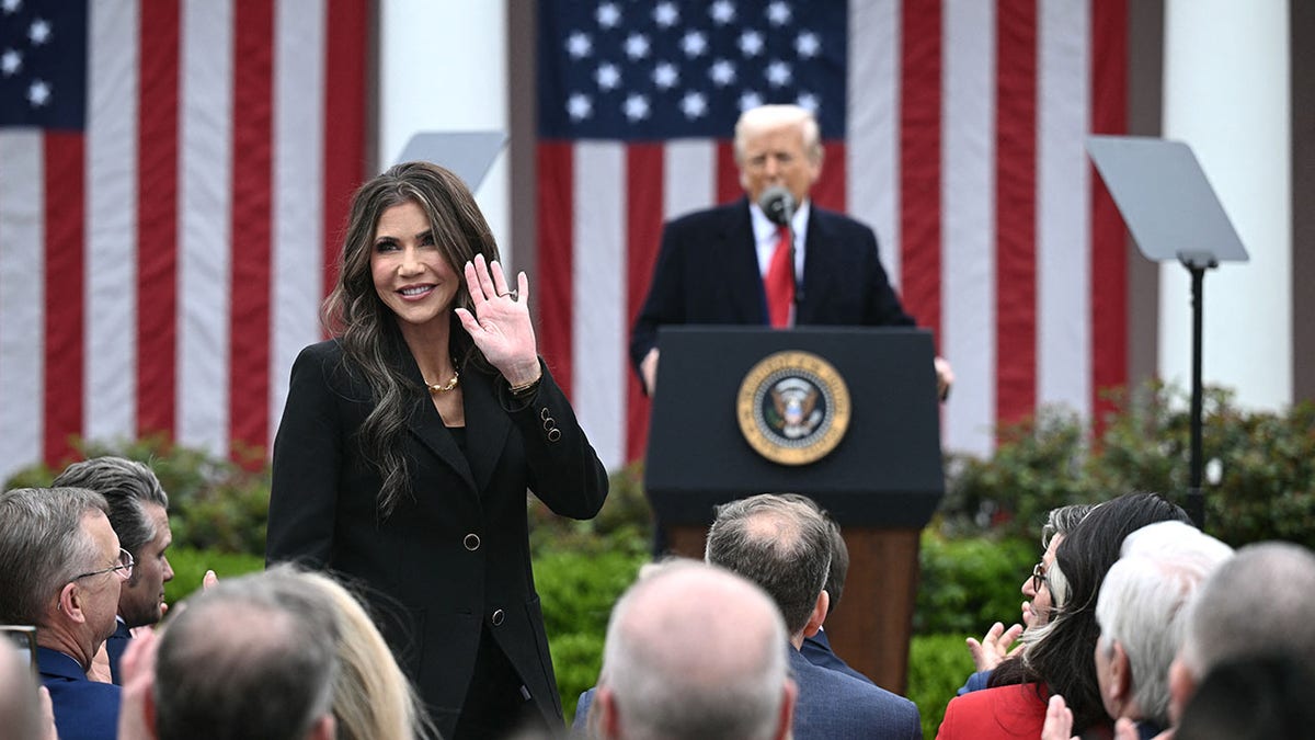 Noem stands and waves during Trump's Rose Garden speech