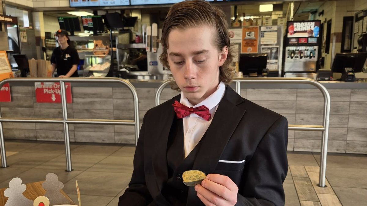 Will Turner stares at a rock while in a suit