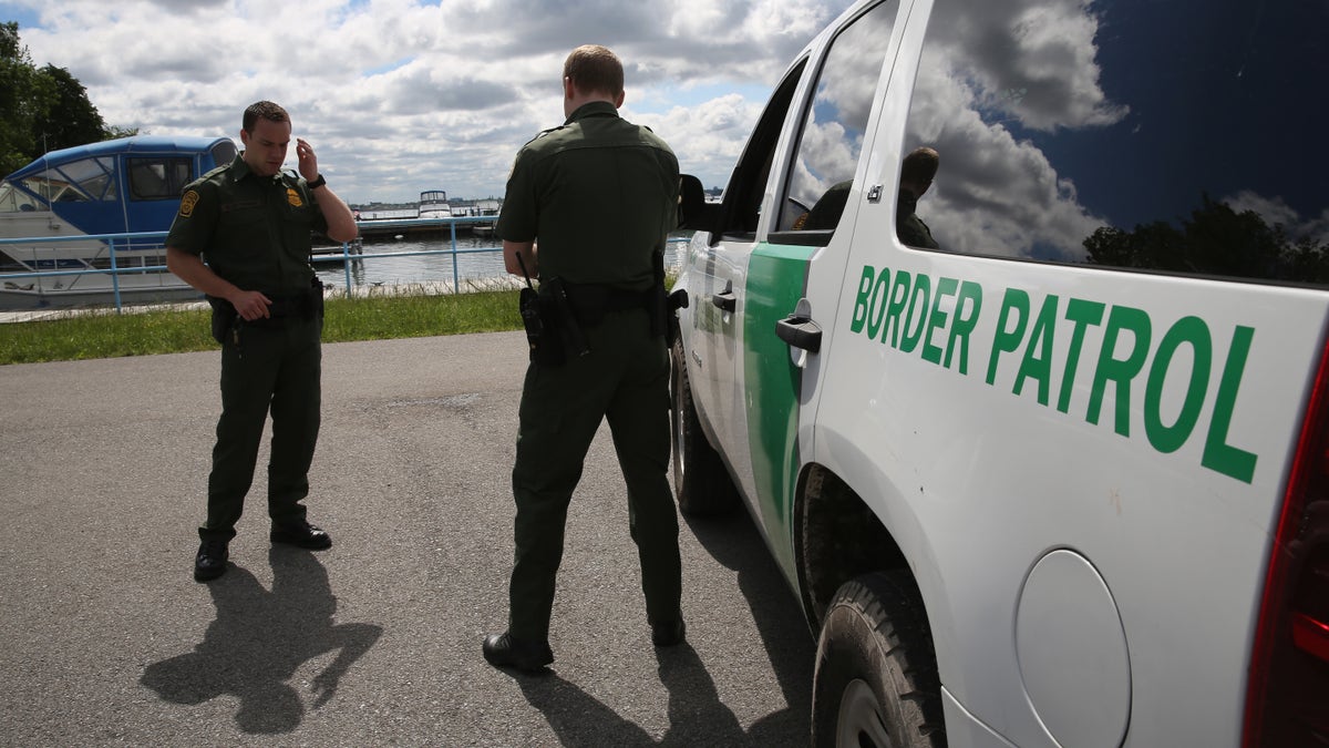 BEAVER ISLAND STATE PARK, NY - JUNE 03: U.S. Border Patrol agents talk while at a marina on the Niagara River at the U.S.-Canada border on June 3, 2013 in Beaver Island State Park, New York. U.S. Customs and Border Protection, which includes the Border Patrol, monitors the 5,525 mile long border, including Alaska, forming the longest international border between two countries in the world. (Photo by John Moore/Getty Images)