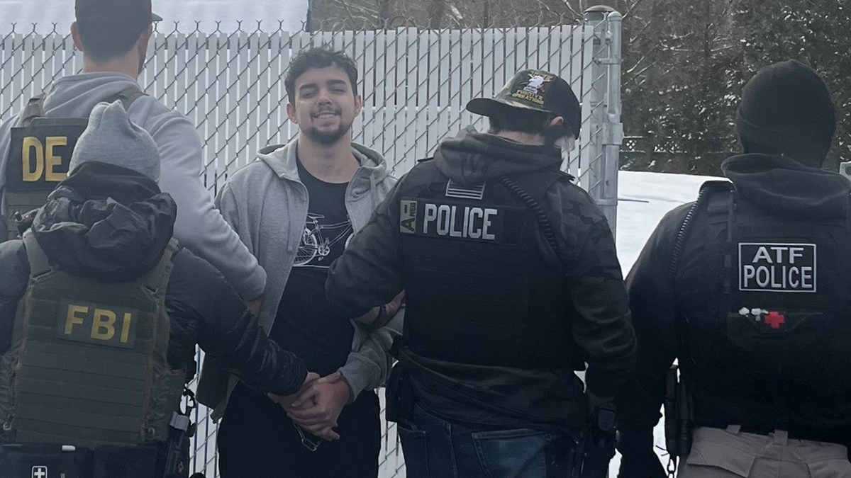 Caio Vitor Guimaraes-Silva, 21 surrounded by federal agents
