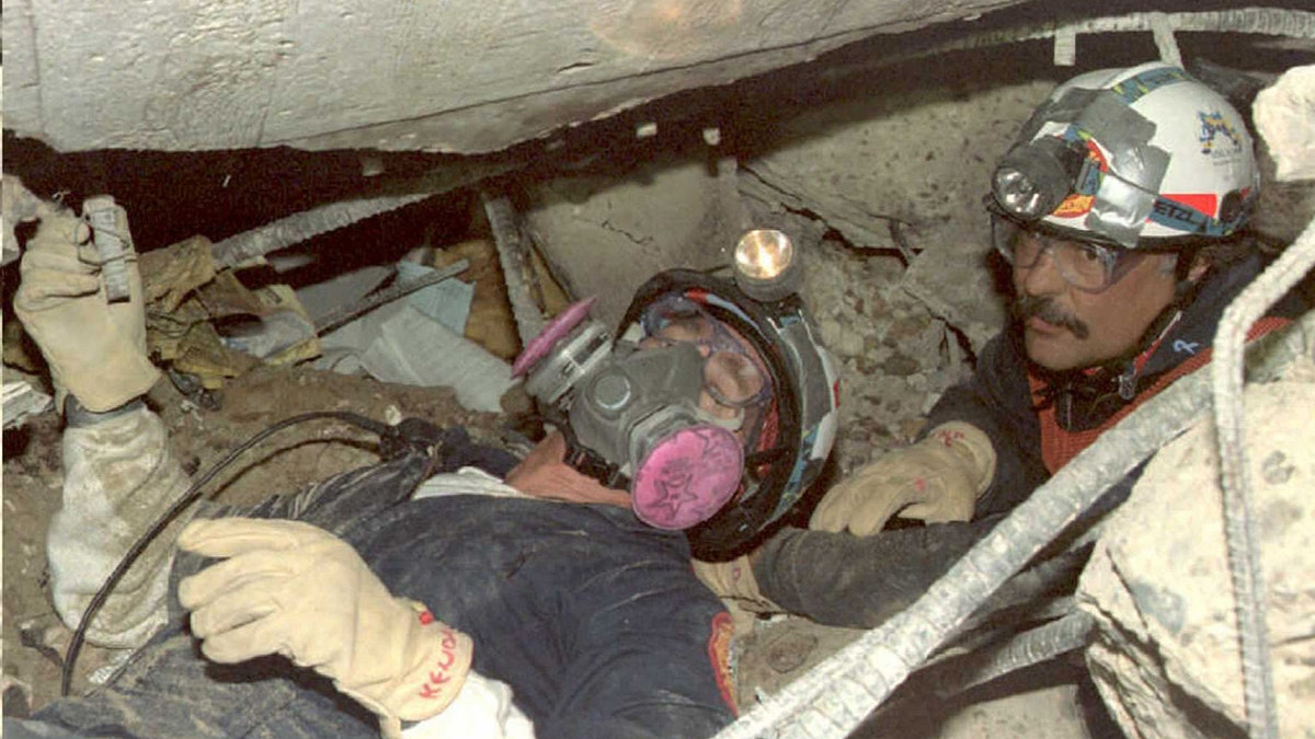 Rescuers searching through rubble.