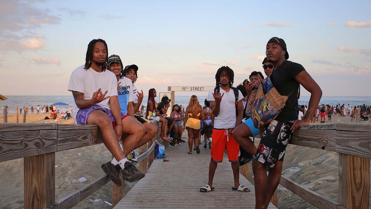 A group of guys hanging out on the boardwalk after being on Tybee Island beach for Orange Crush