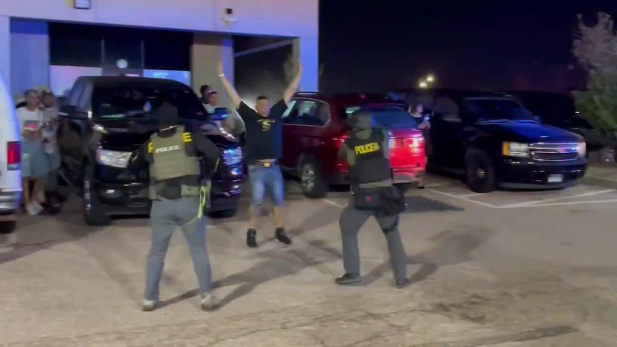 officers stop people from fleeing outside