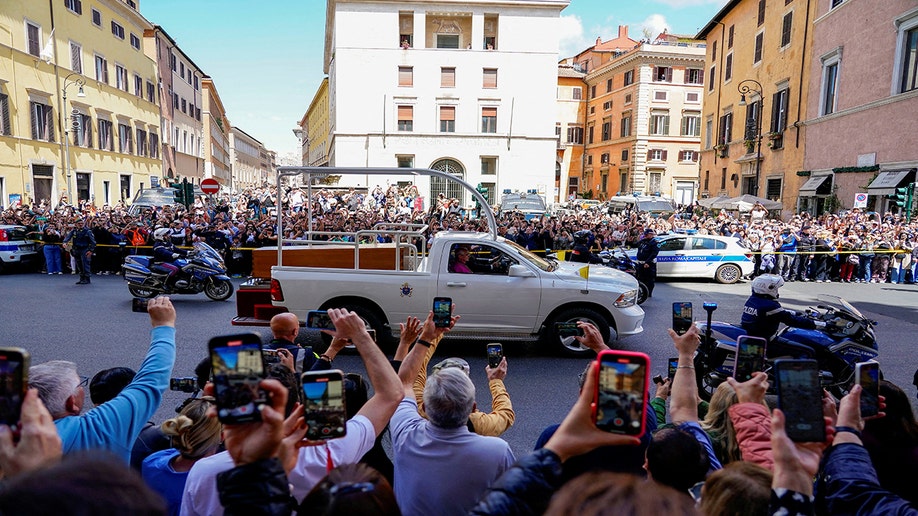 People taking pictures of Pope Francis' casket