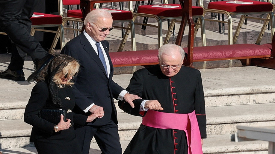 Former President Biden and former First Lady Jill Biden walk with a cardinal.