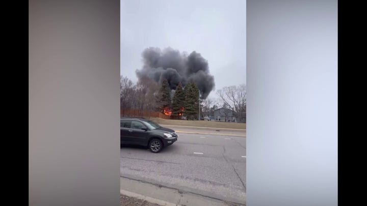 Home is engulfed in flames following a plane crash