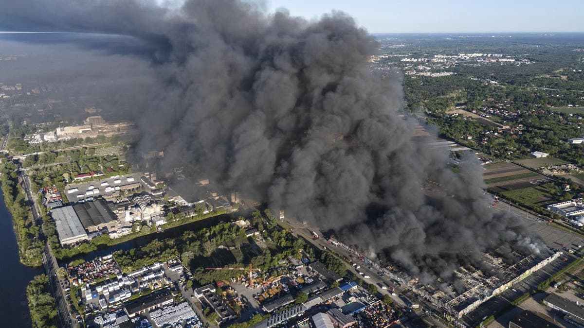 A fire burns from a vast shopping complex in Warsaw, Poland, May 12, 2024. (AP Photo/Norbert Ofmanski, File)
