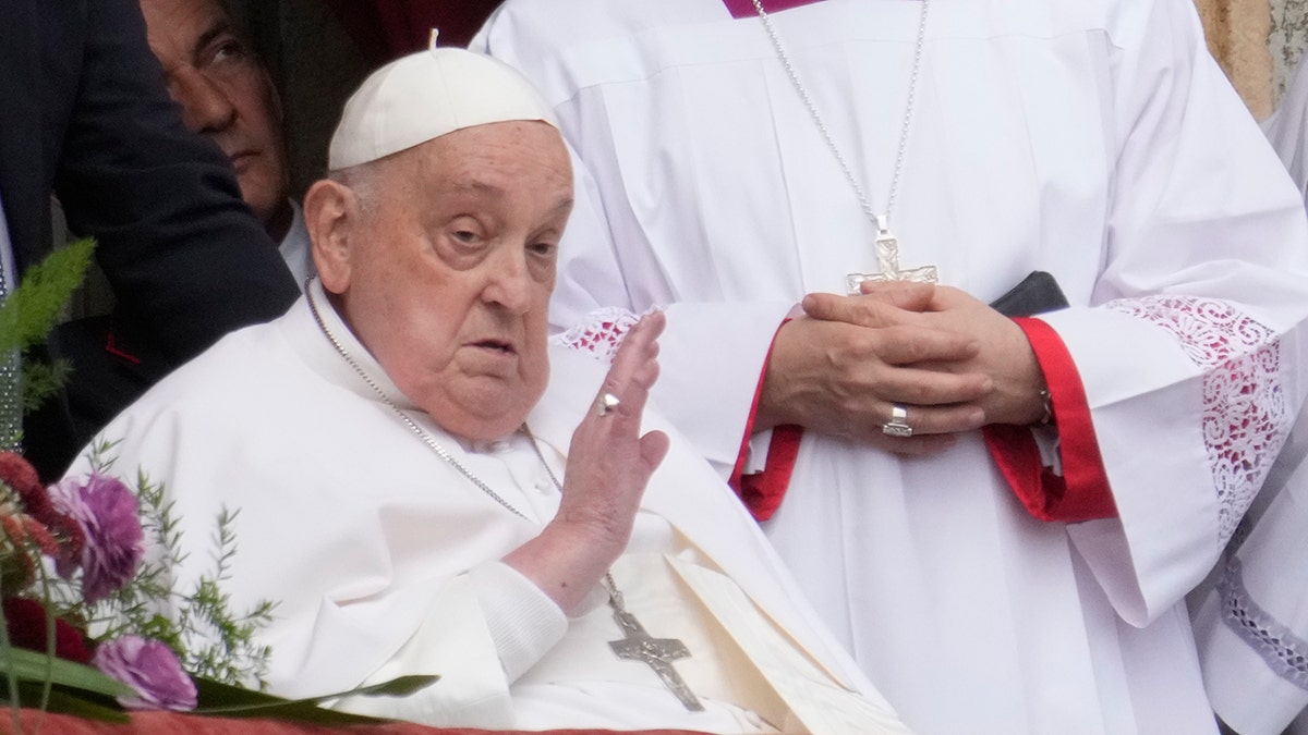 Pope Francis waves to people