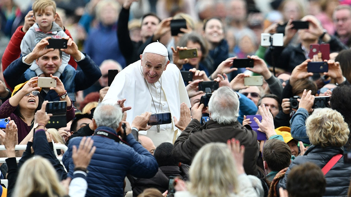 Pope Francis with people in a crowd