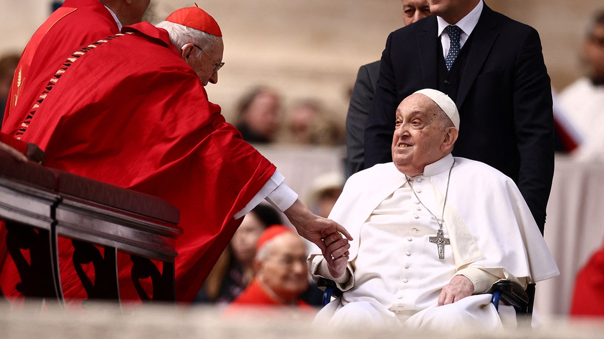Pope Francis shaking hands with Cardinal Giovanni Battista Re