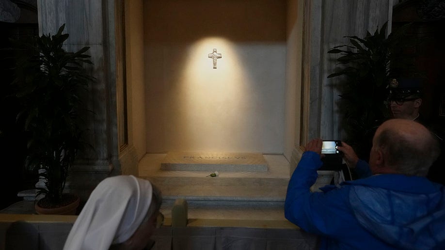 White cast over a cross over the tomb of Pope Francis
