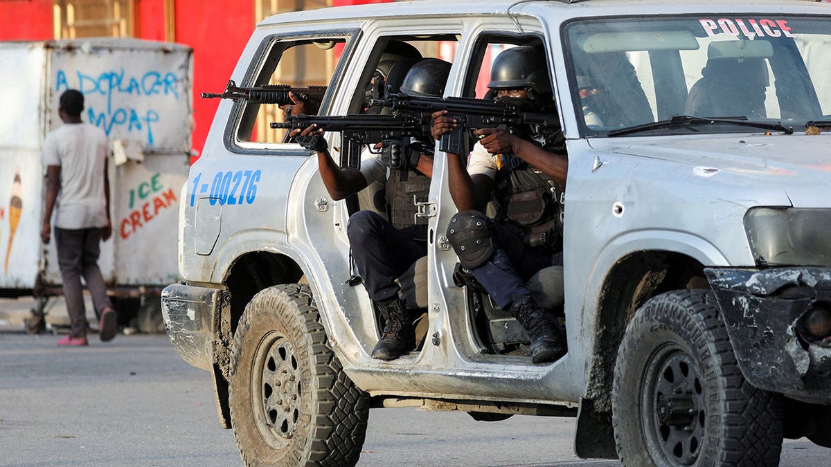 Police officers in Haiti with guns drawn