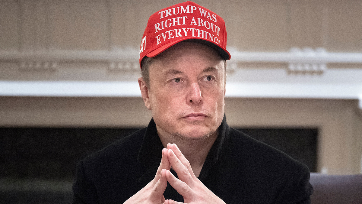 Elon Musk closeup shot in red "Trump was right about everything" hat