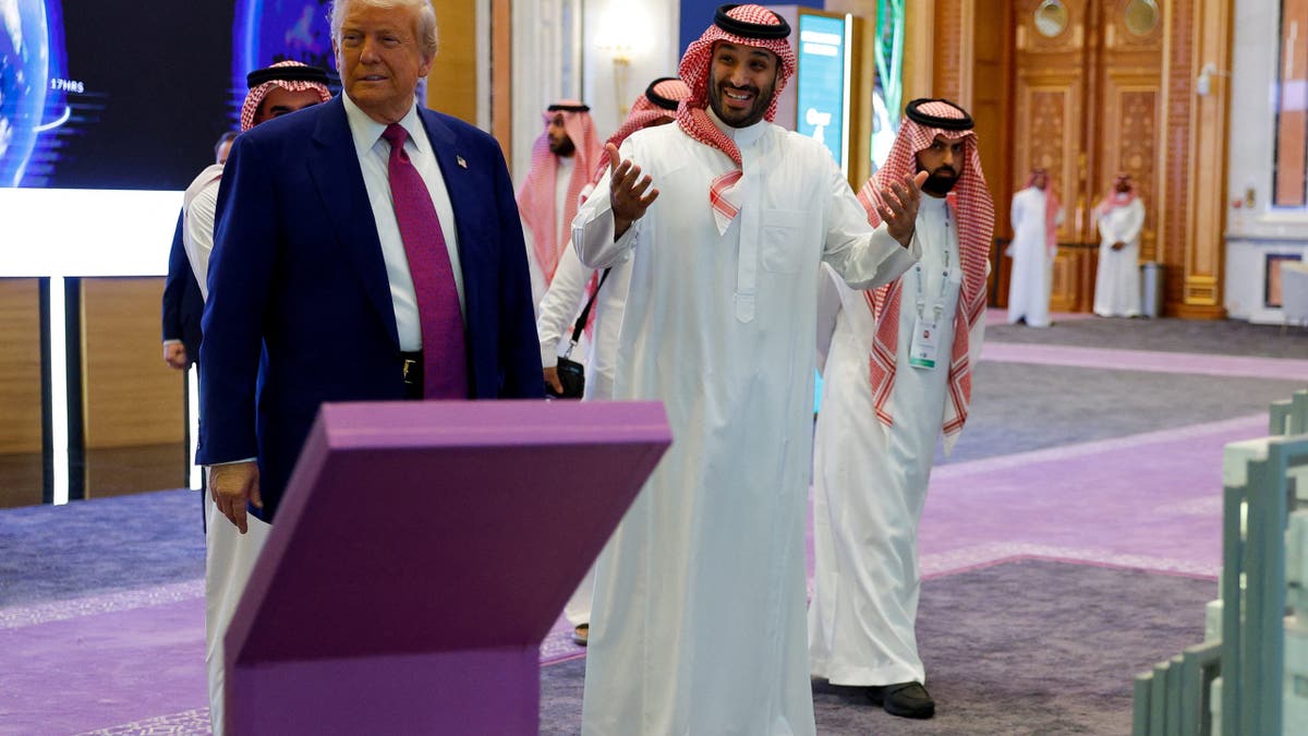 Saudi Crown Prince Mohammed Bin Salman reacts next to U.S. President Donald Trump during the Saudi-U.S. Investment Forum, in Riyadh, Saudi Arabia, May 13, 2025