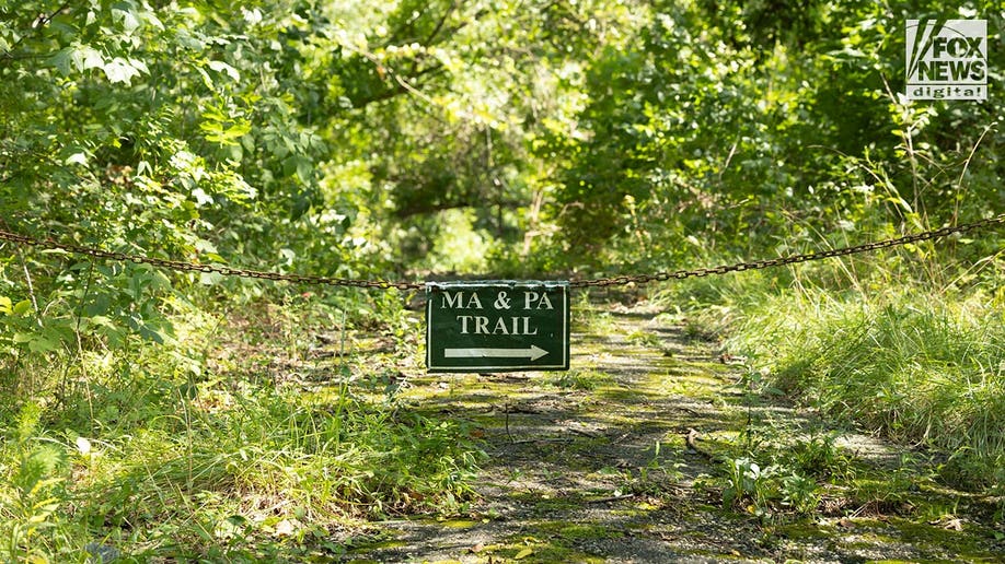 A close up of a sign on a chain