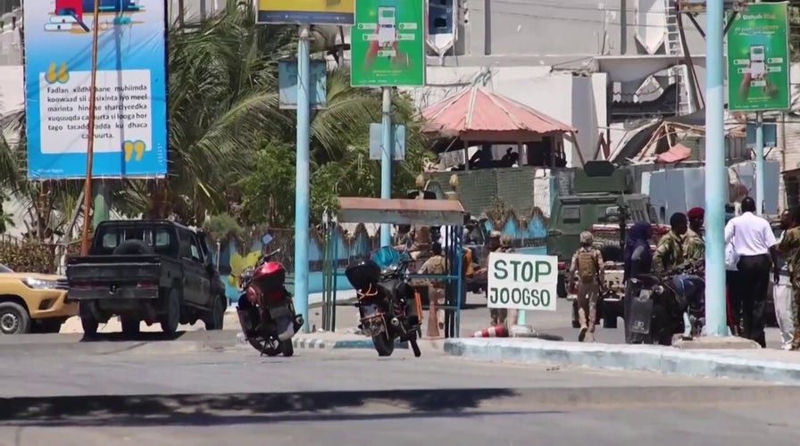Soldiers guard the entrance of a hotel in Mogadishu, Somalia after a jihadist attack
