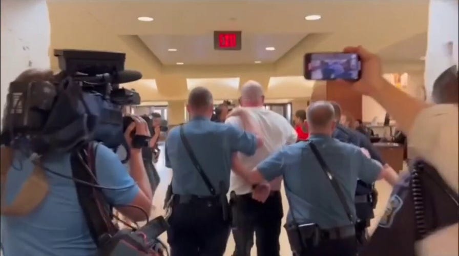 Satanic leader shouts 'Hail Satan' as he's arrested inside the Kansas Statehouse