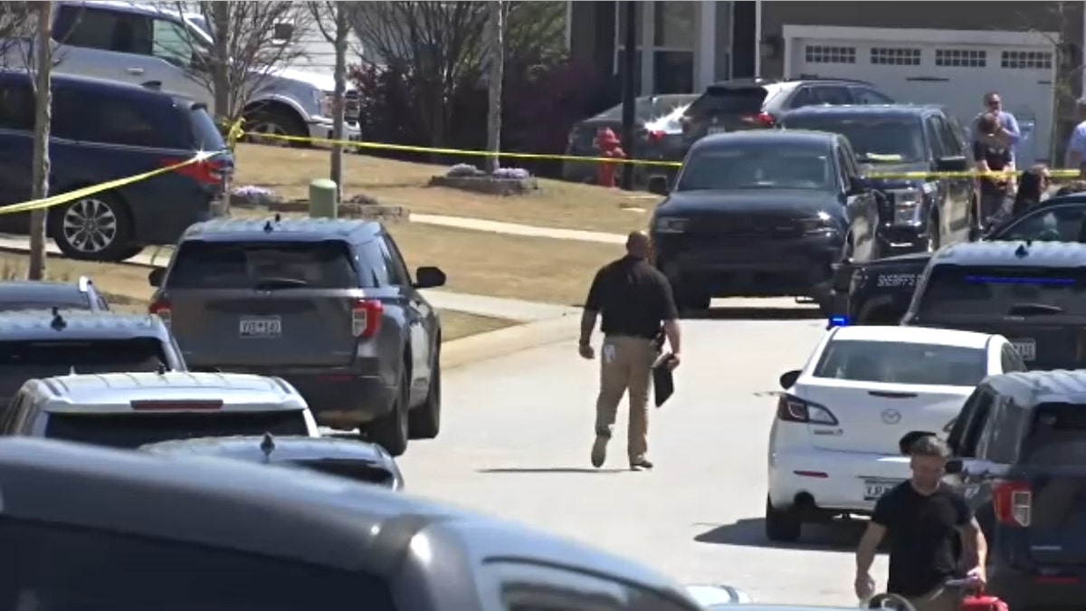 Law enforcement responds to the scene of the Samarel family deaths on March 28